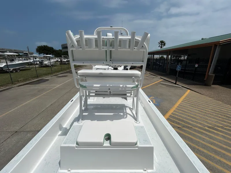 Slide: The Image of 2023 Shallow Sport 21 Sport boat with seating, parked outdoors under a cloudy sky. - 8