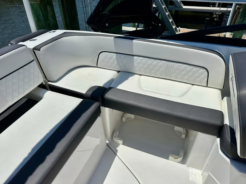 Slide: The Image of 2019 Monterey M45 boat interior with white and black seating, diamond-patterned upholstery. - 12