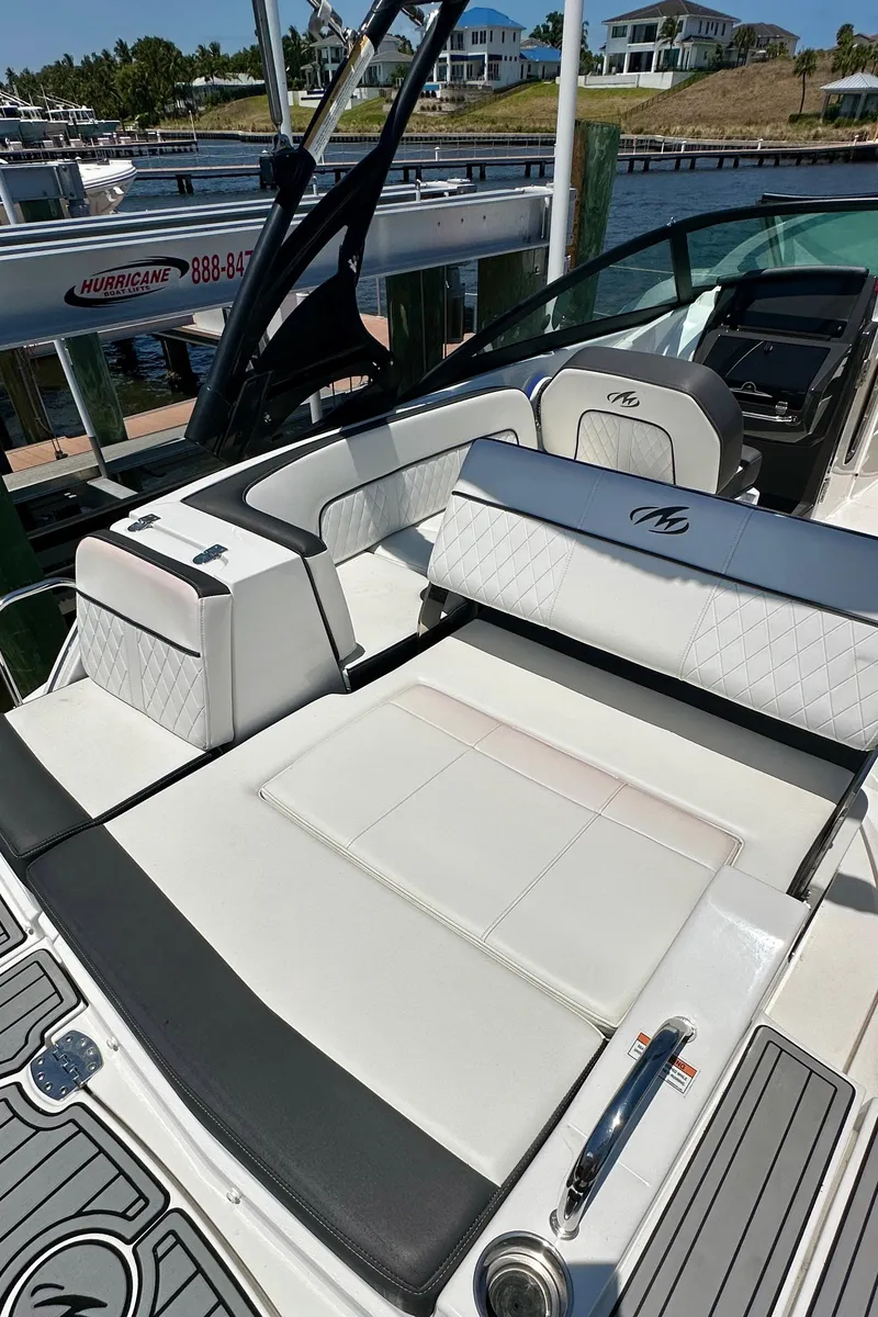 Slide: The Image of 2019 Monterey M45 boat with luxurious white seating, docked near waterfront homes. - 14