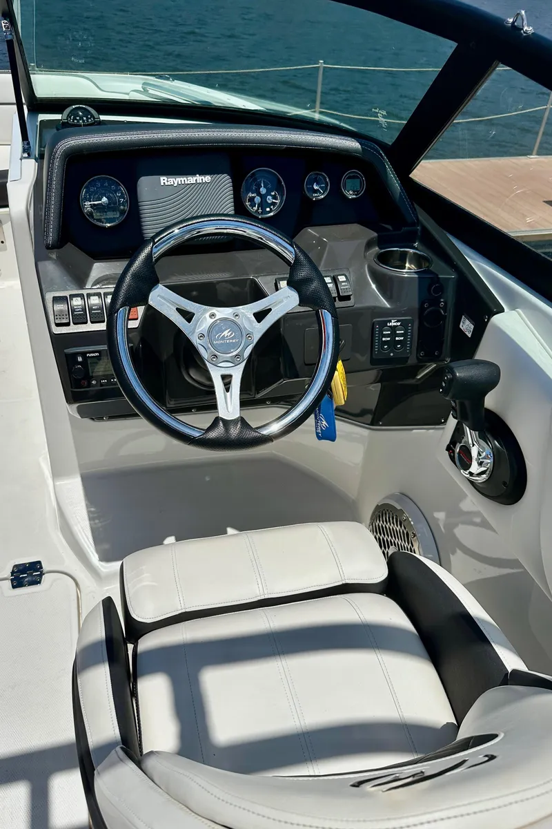 Slide: The Image of 2019 Monterey M45 boat cockpit with steering wheel and dashboard controls. - 18