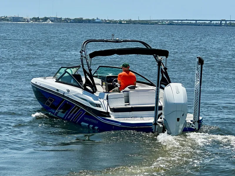 Slide: The Image of 2019 Monterey M45 boat cruising on open water with a person in an orange shirt. - 2