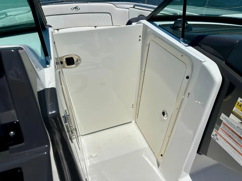 Slide: The Image of 2019 Monterey M45 boat interior with white storage compartment and seating. - 24