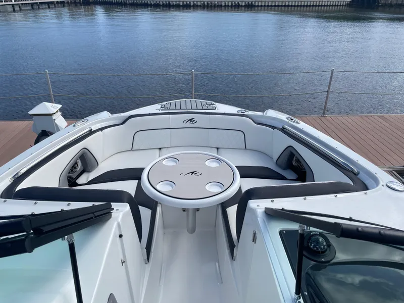 Slide: The Image of 2019 Monterey M45 boat with spacious seating and table, docked by the water. - 27