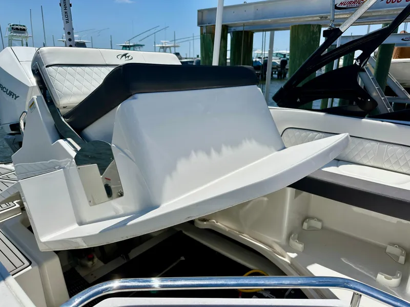 Slide: The Image of 2019 Monterey M45 boat interior with seating and steering wheel, docked at marina. - 28