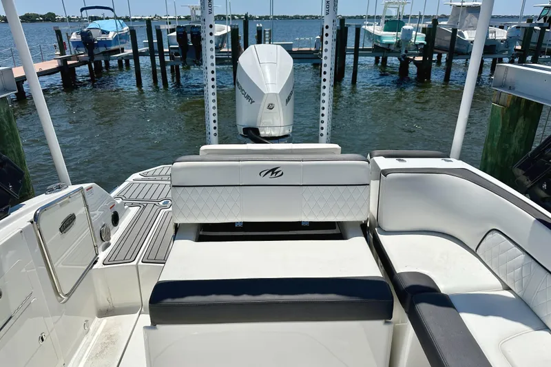 Slide: The Image of 2019 Monterey M45 boat interior with seating, docked by the water. - 7