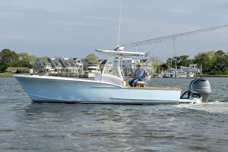 Slide: The Image of 2003 Shearline 23 Center Console boat cruising on a calm waterway. - 10