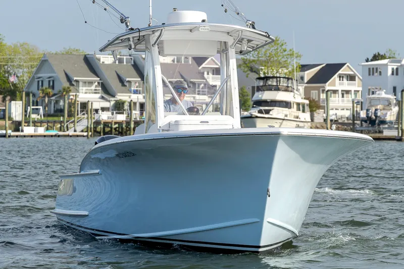 Slide: The Image of 2003 Shearline 23 Center Console boat on water near waterfront homes. - 12