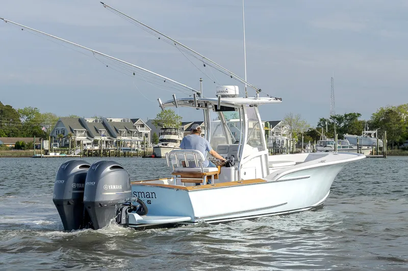 Slide: The Image of 2003 Shearline 23 Center Console boat with dual Yamaha engines on a calm waterway. - 13