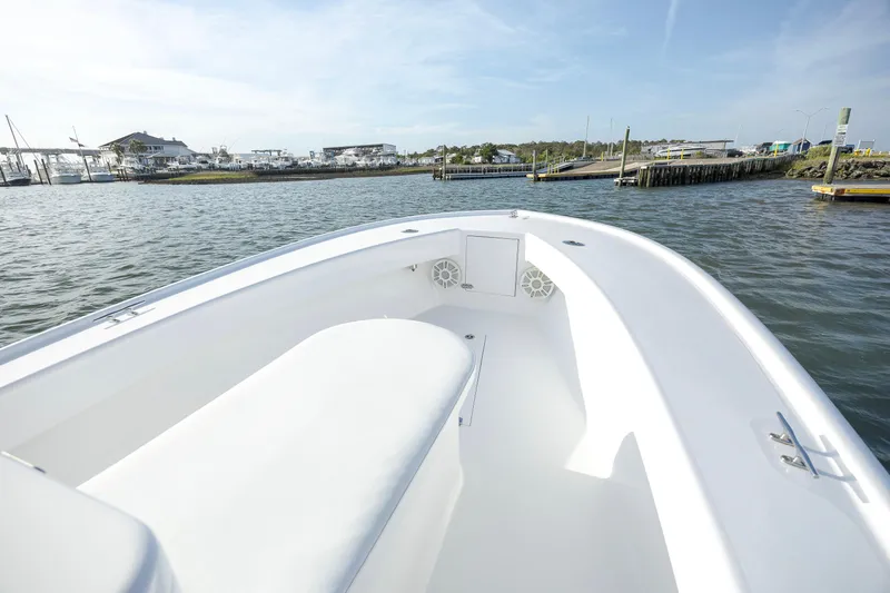 Slide: The Image of 2003 Shearline 23 Center Console boat on calm water, showcasing spacious deck and coastal scenery. - 16