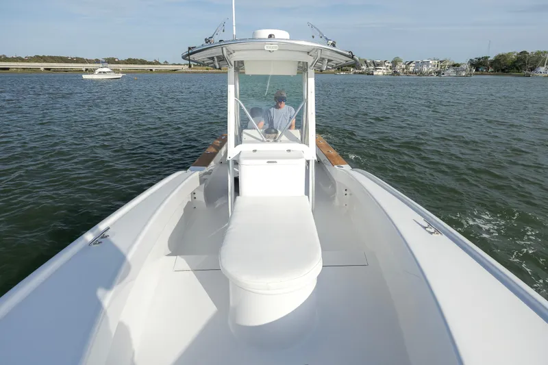 Slide: The Image of 2003 Shearline 23 Center Console boat on calm water, featuring spacious deck and helm. - 18