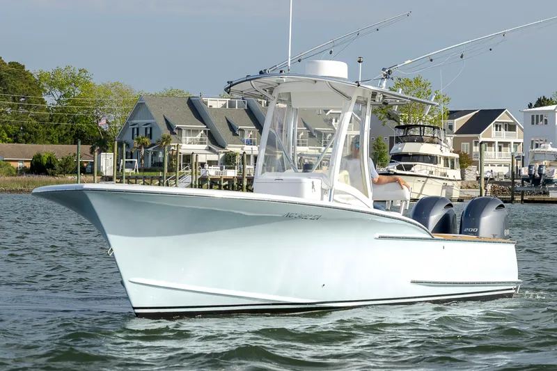 Slide: The Image of 2003 Shearline 23 Center Console boat on water near waterfront homes. - 4