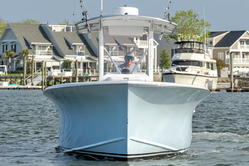 Slide: The Image of 2003 Shearline 23 Center Console boat on water, with waterfront homes in the background. - 6