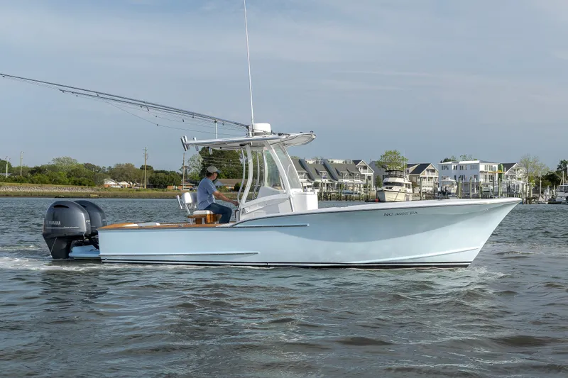 Slide: The Image of 2003 Shearline 23 Center Console boat cruising on a calm waterway. - 7