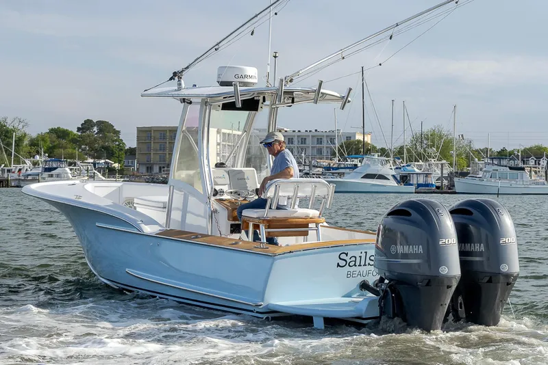 Slide: The Image of 2003 Shearline 23 Center Console boat with dual Yamaha engines on the water. - 8