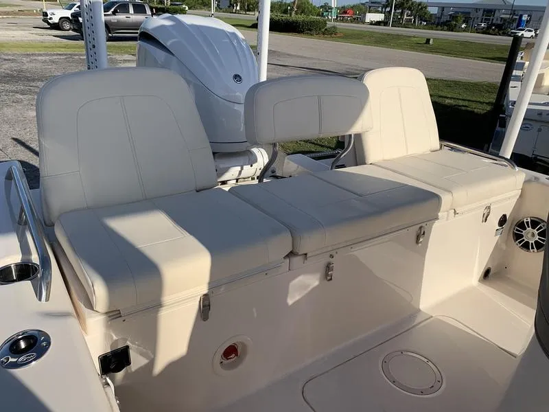 Slide: The Image of 2023 Grady-White 251 Coastal Explorer boat with cushioned seating and outboard motor. - 10