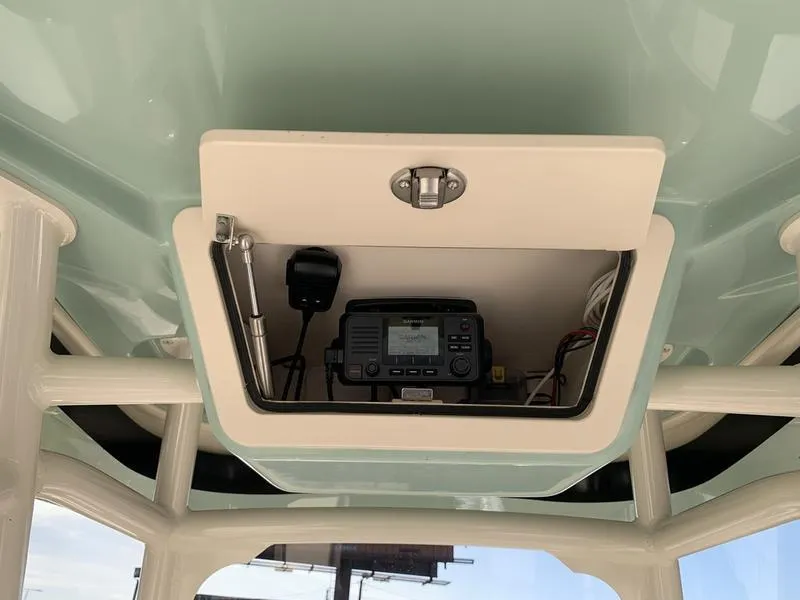 Slide: The Image of 2023 Grady-White 251 Coastal Explorer boat console with electronic equipment storage. - 13