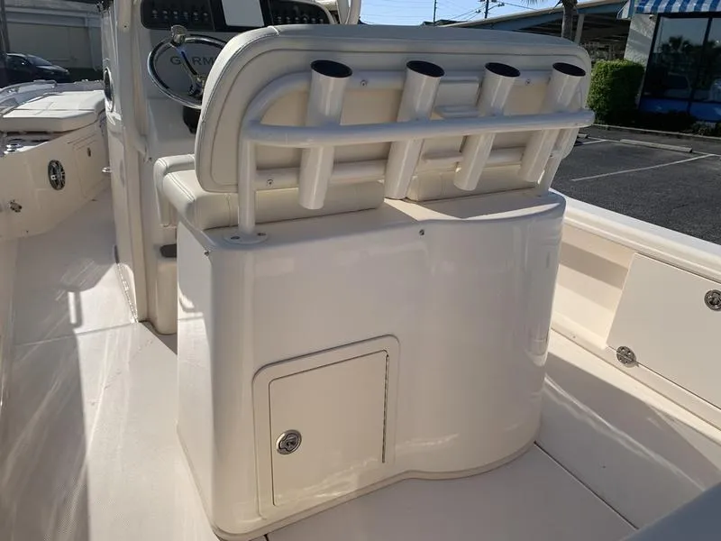 Slide: The Image of 2023 Grady-White 251 Coastal Explorer boat interior with rod holders and storage compartment. - 16