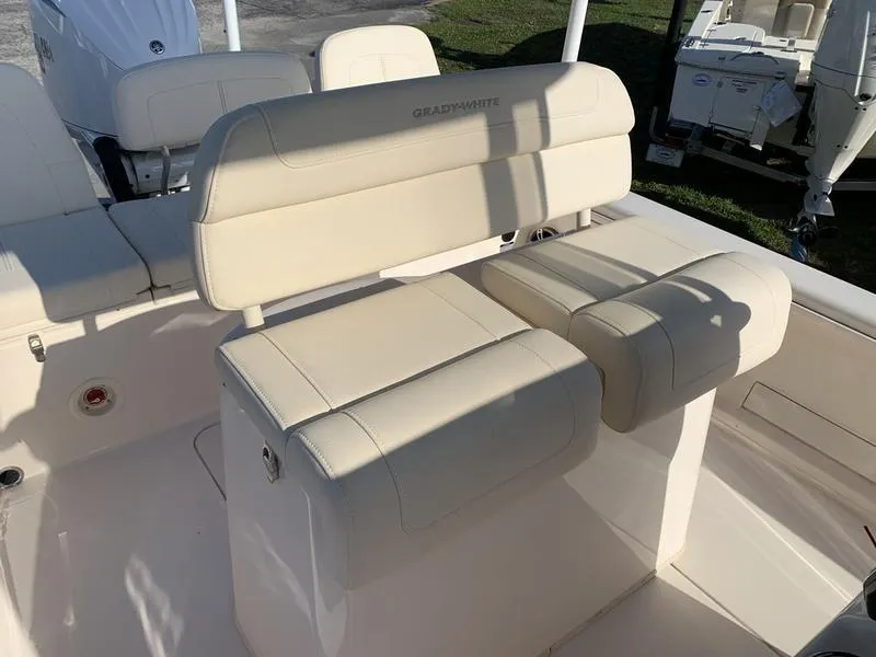 Slide: The Image of 2023 Grady-White 251 Coastal Explorer boat seating, featuring beige cushioned seats. - 18
