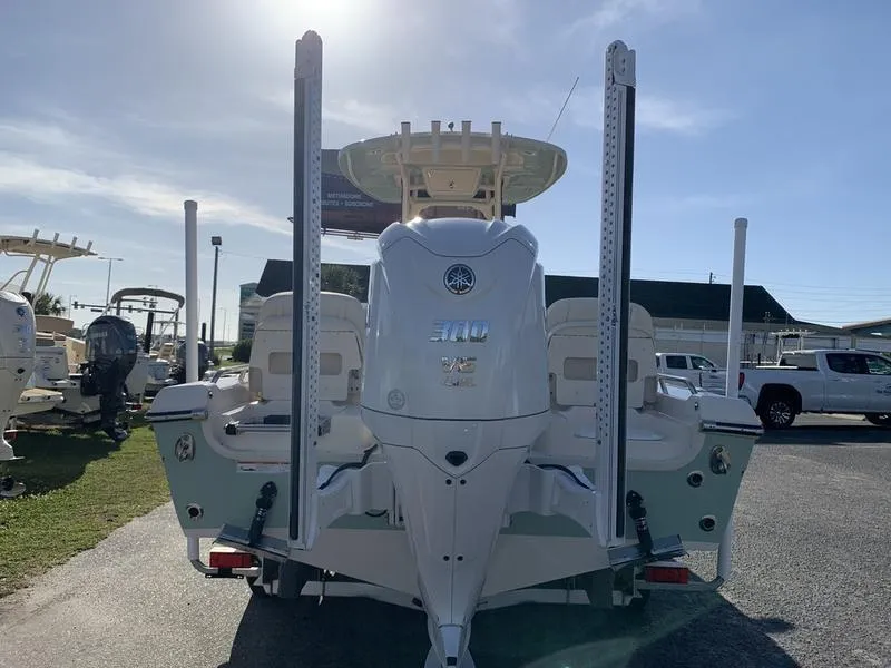 Slide: The Image of 2023 Grady-White 251 Coastal Explorer boat, rear view, parked outdoors. - 2