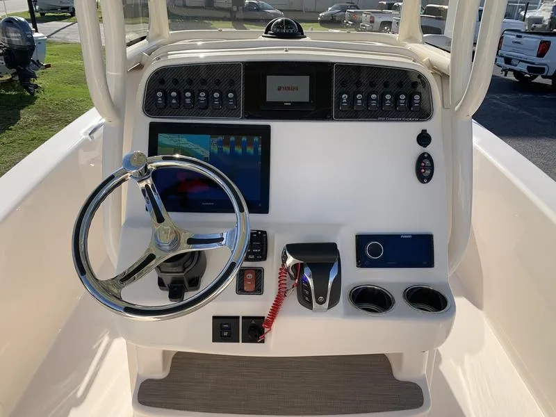 Slide: The Image of 2023 Grady-White 251 Coastal Explorer boat dashboard with steering wheel and electronic controls. - 20