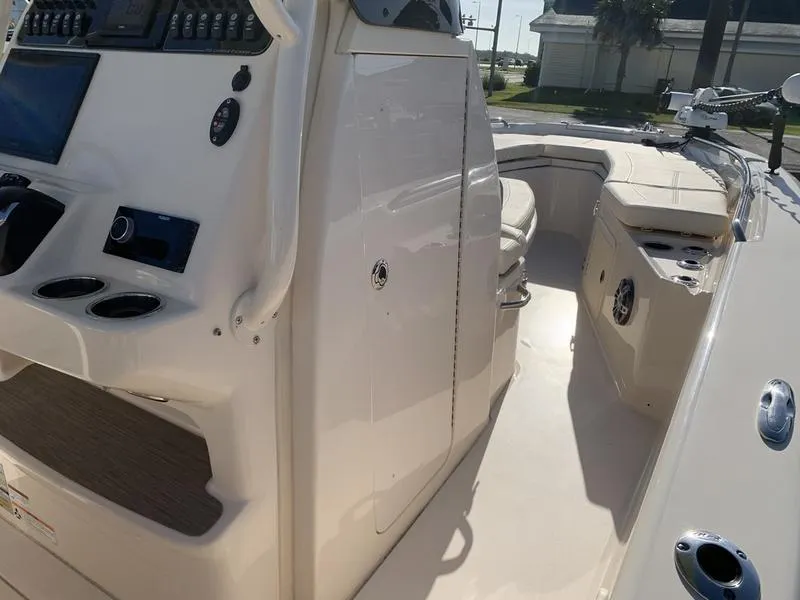 Slide: The Image of 2023 Grady-White 251 Coastal Explorer boat interior with seating and control panel. - 25