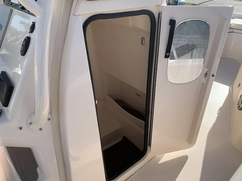 Slide: The Image of 2023 Grady-White 251 Coastal Explorer boat cabin interior with open door. - 26