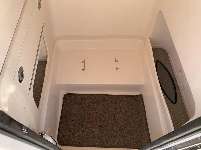 Slide: The Image of Interior cabin of 2023 Grady-White 251 Coastal Explorer boat, featuring storage and carpeted flooring. - 27