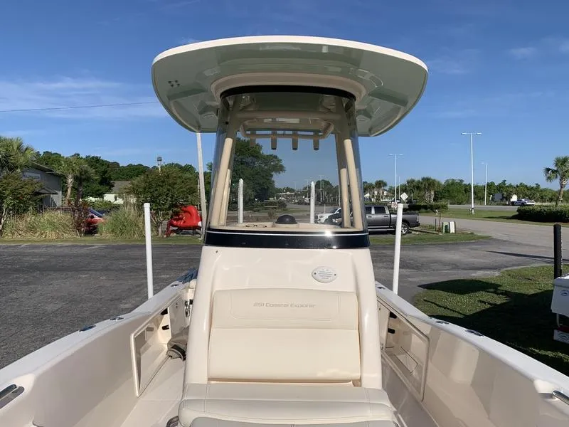 Slide: The Image of 2023 Grady-White 251 Coastal Explorer boat with T-top, parked outdoors under clear sky. - 30