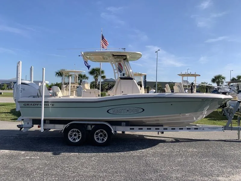 Slide: The Image of 2023 Grady-White 251 Coastal Explorer boat on trailer, parked outdoors under clear sky. - 5