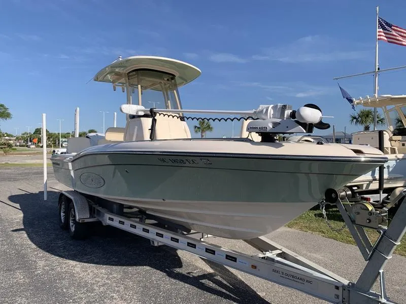 Slide: The Image of 2023 Grady-White 251 Coastal Explorer boat on trailer, parked outdoors under clear blue sky. - 6