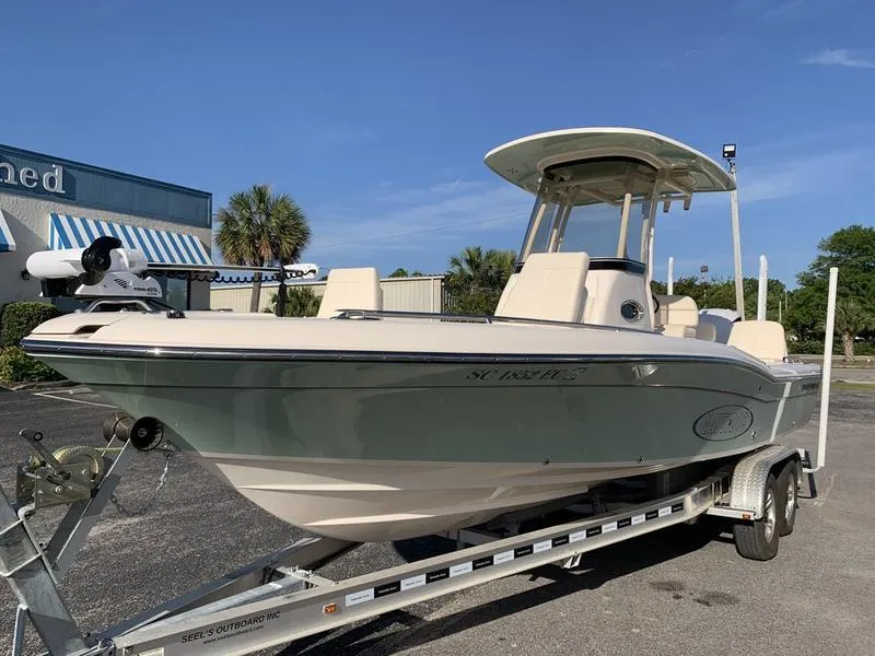 Slide: The Image of 2023 Grady-White 251 Coastal Explorer boat on trailer, parked outdoors under clear blue sky. - 8
