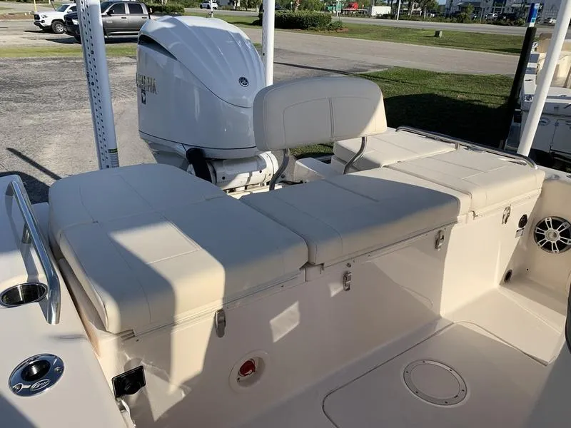 Slide: The Image of 2023 Grady-White 251 Coastal Explorer boat interior with seating and engine view. - 9