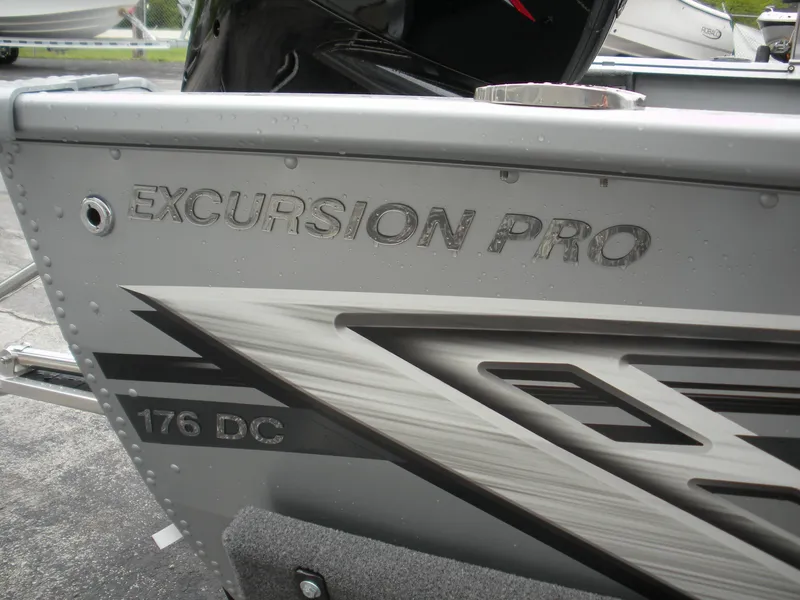 Slide: The Image of 2024 Smoker Craft Excursion Pro 176 DC Pro boat, close-up of side detailing and logo. - 10