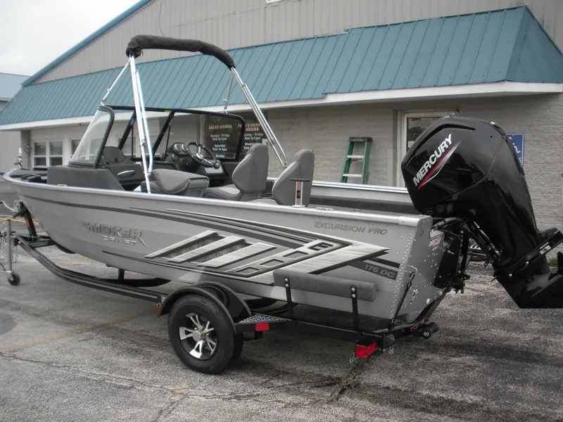Slide: The Image of 2024 Smoker Craft Excursion Pro 176 DC Pro boat with Mercury engine on trailer. - 12