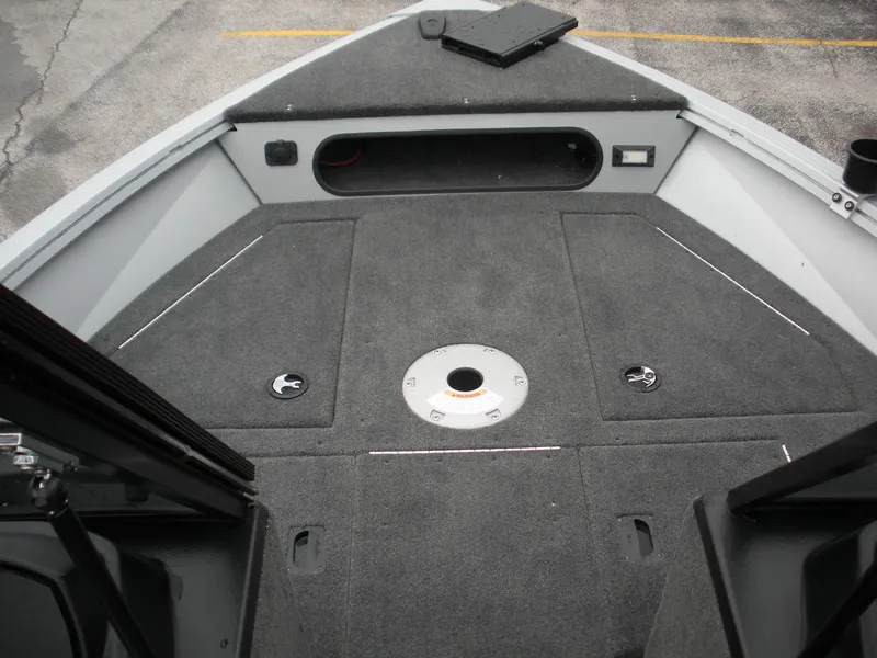 Slide: The Image of 2024 Smoker Craft Excursion Pro 176 DC Pro boat interior with carpeted deck and storage compartments. - 2