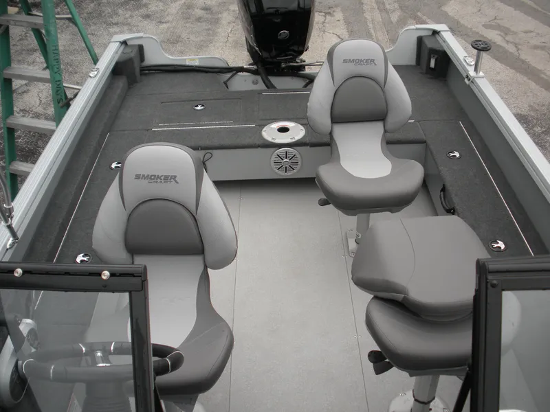 Slide: The Image of 2024 Smoker Craft Excursion Pro 176 DC Pro boat interior with gray seating and steering console. - 4