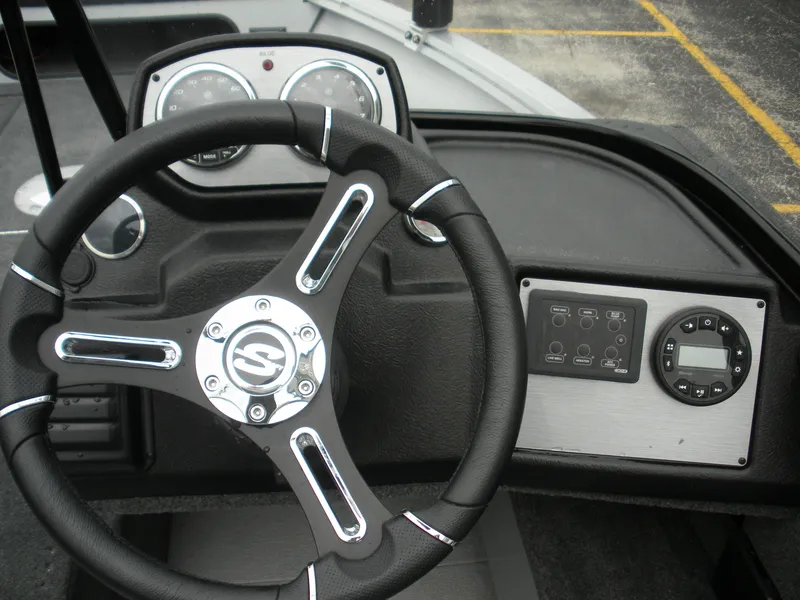 Slide: The Image of 2024 Smoker Craft Excursion Pro 176 DC Pro dashboard with steering wheel and control panel. - 5