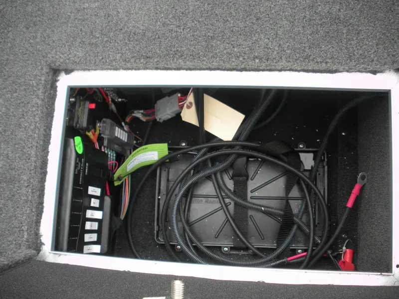 Slide: The Image of 2024 Smoker Craft Excursion Pro 176 DC Pro boat wiring compartment with cables and electrical components. - 7