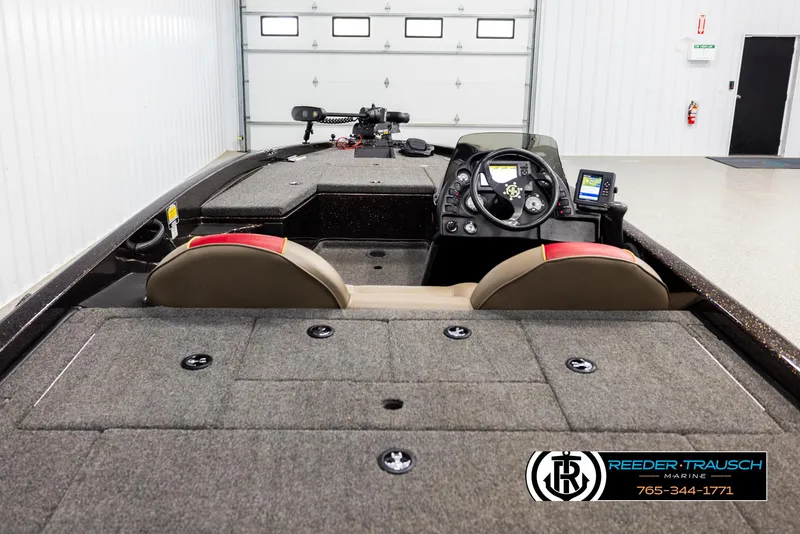 Slide: The Image of 2001 Ranger R81 boat interior with steering console and seating in a garage setting. - 11
