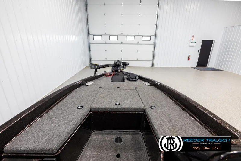 Slide: The Image of 2001 Ranger R81 boat interior in a garage, featuring a spacious deck and modern design. - 13