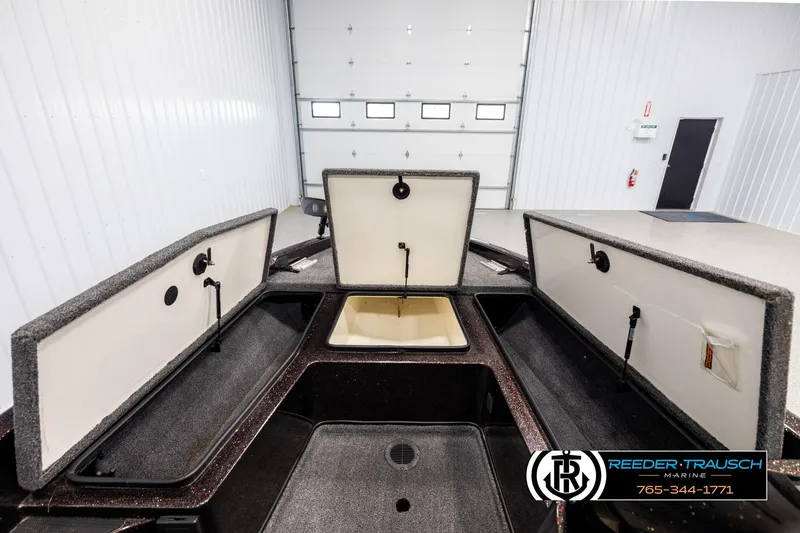 Slide: The Image of 2001 Ranger R81 boat storage compartments open in a garage setting. - 14