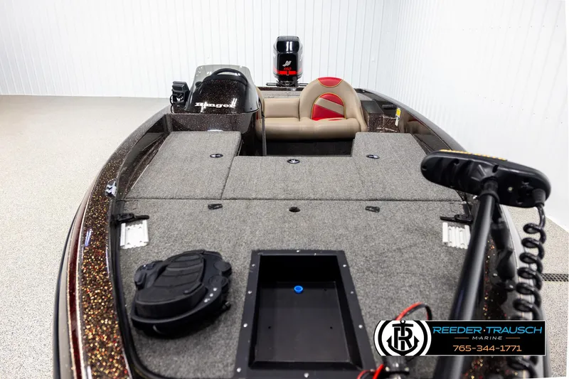 Slide: The Image of 2001 Ranger R81 boat interior with seating and motor, displayed in a showroom. - 15