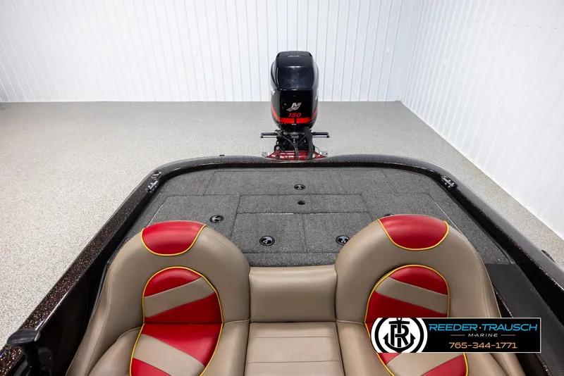 Slide: The Image of 2001 Ranger R81 boat interior with red and beige seats, featuring a Mercury outboard motor. - 17