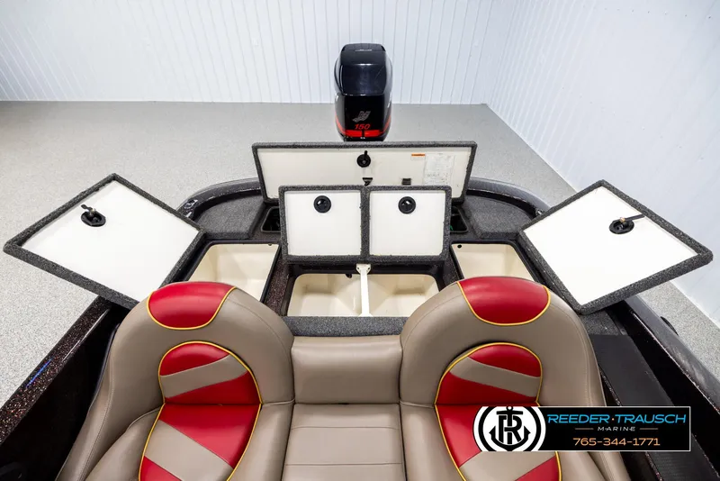 Slide: The Image of Interior of a 2001 Ranger R81 boat with open storage compartments and dual-tone seats. - 18