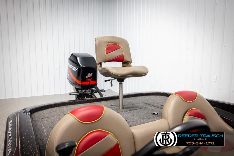 Slide: The Image of 2001 Ranger R81 boat interior with Mercury 150 engine, featuring red and beige seating. - 21