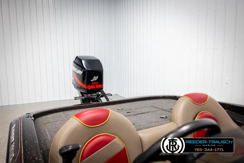 Slide: The Image of 2001 Ranger R81 boat with Mercury 150 engine in a garage setting. - 22