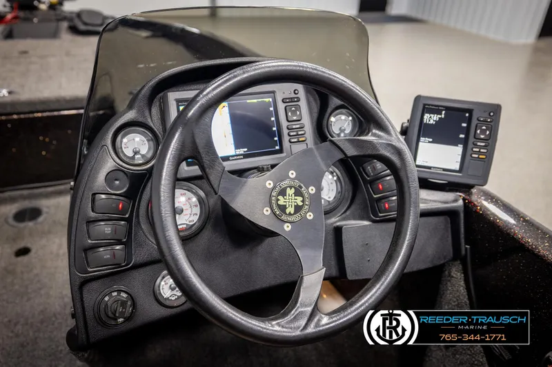 Slide: The Image of Steering console of a 2001 Ranger R81 boat with navigation screens and controls. - 25