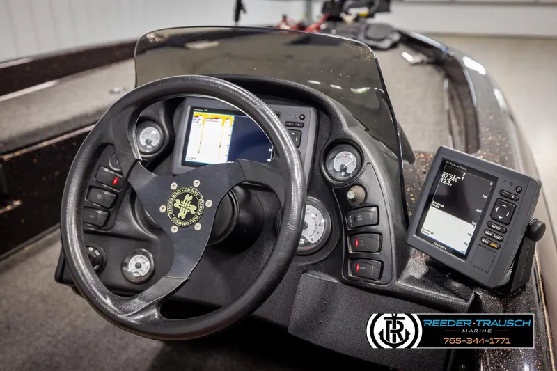Slide: The Image of 2001 Ranger R81 boat dashboard with steering wheel and electronic displays. - 26