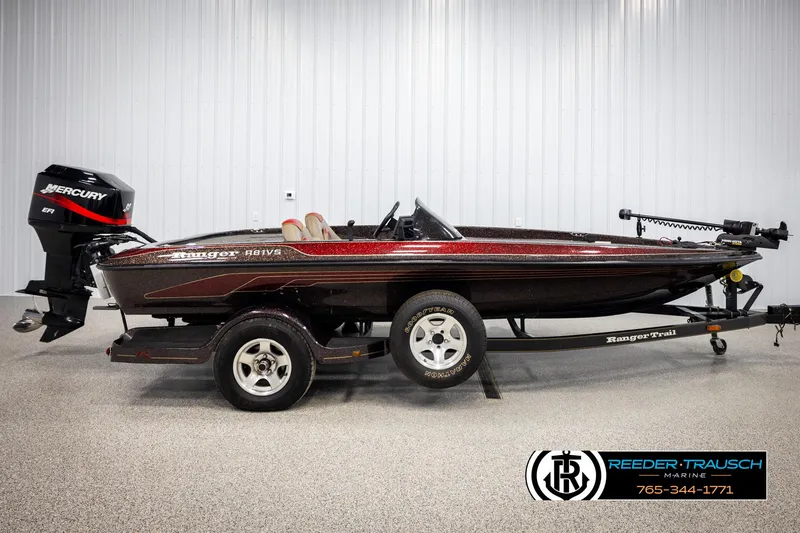 Slide: The Image of 2001 Ranger R81 boat with trailer, featuring a Mercury outboard motor, displayed indoors. - 3