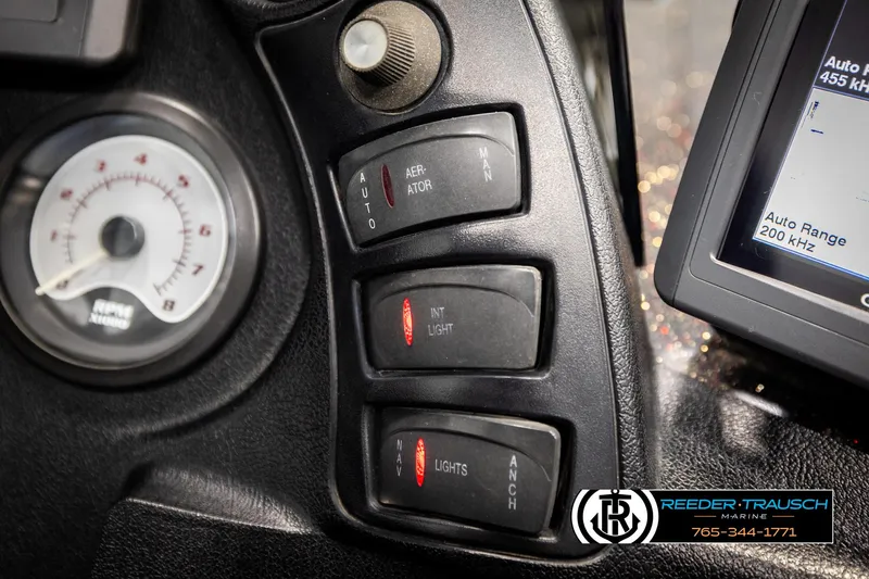 Slide: The Image of Dashboard controls of a 2001 Ranger R81 boat with gauge and electronic display. - 35